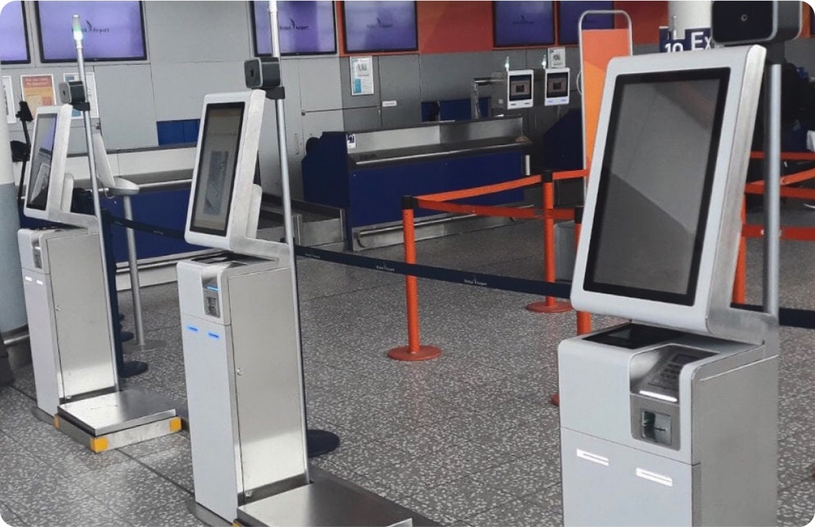 Biometric self-service kiosks at an airport check-in area